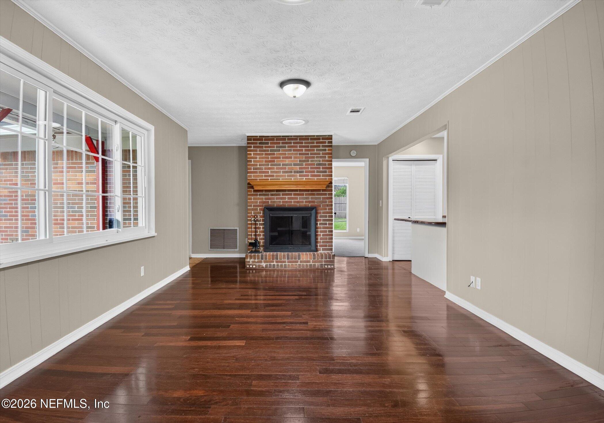 2705 Navajo Road Orange Park, FL 32073 - Photo 11 of 58 a view of empty room with fireplace and wooden floor