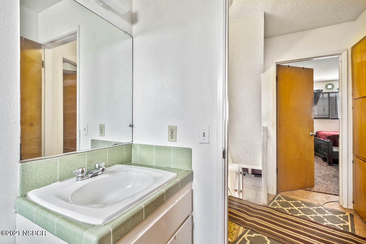 303 Sheila Lane Santa Maria, CA 93458 - Photo 4 of 13 a bathroom with a sink and a mirror