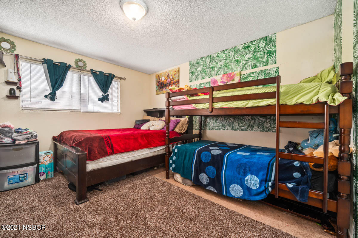 303 Sheila Lane Santa Maria, CA 93458 - Photo 6 of 13 a bedroom with a bed and a window