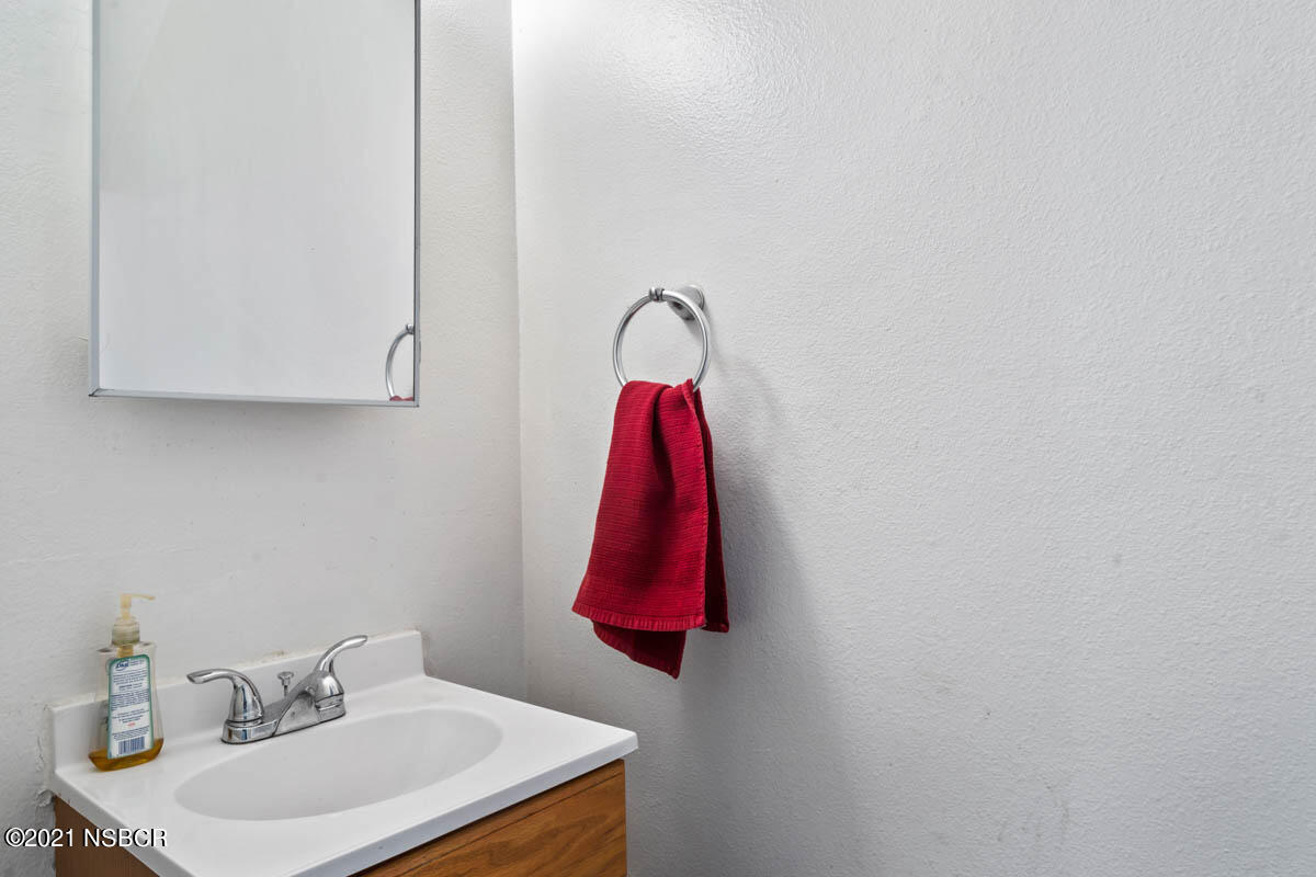 303 Sheila Lane Santa Maria, CA 93458 - Photo 8 of 13 a bathroom with a sink and a mirror