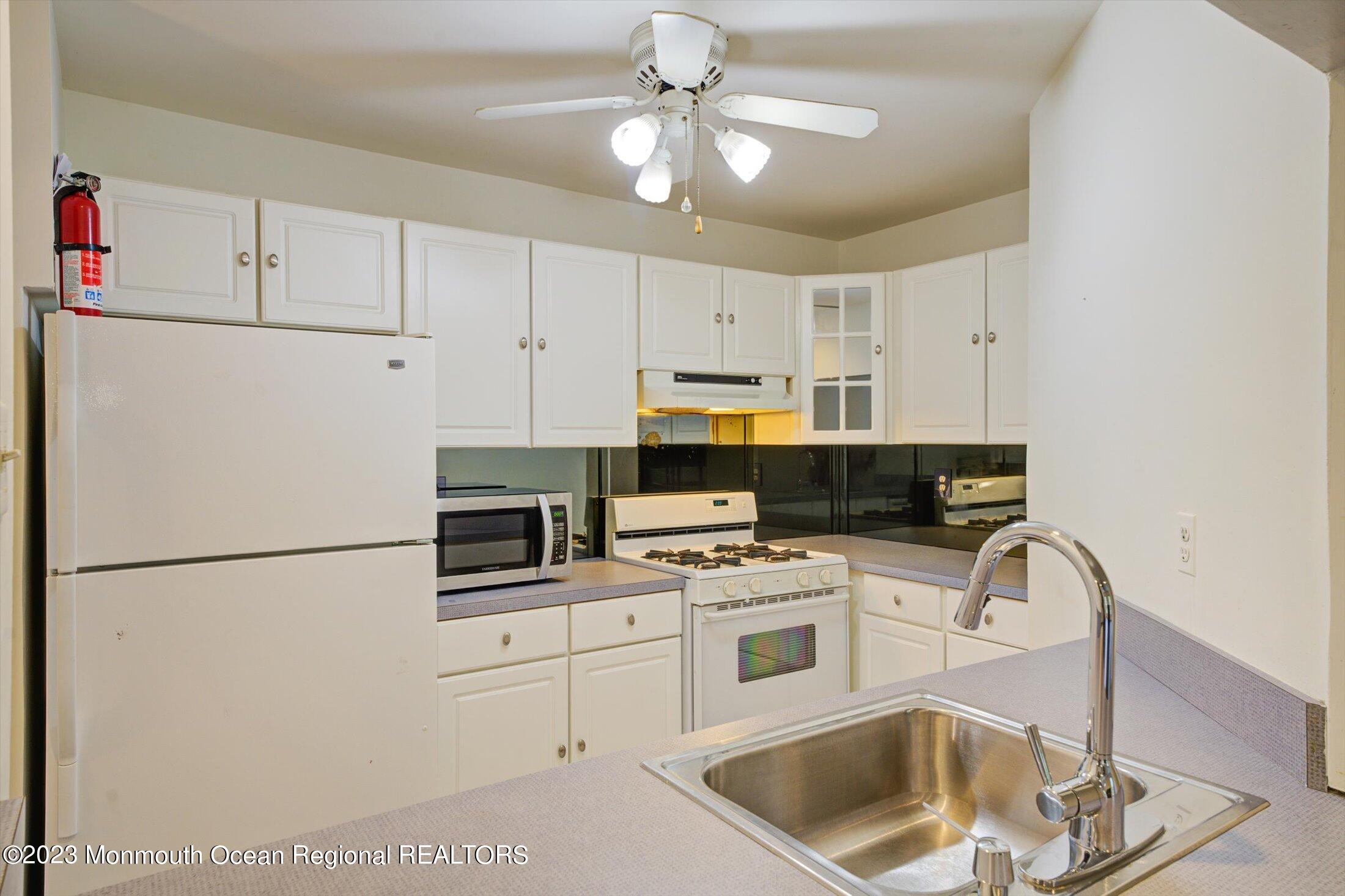 481 Hawthorne Place Morganville, NJ 07751 - Photo 13 of 26 a kitchen with appliances a sink and cabinets