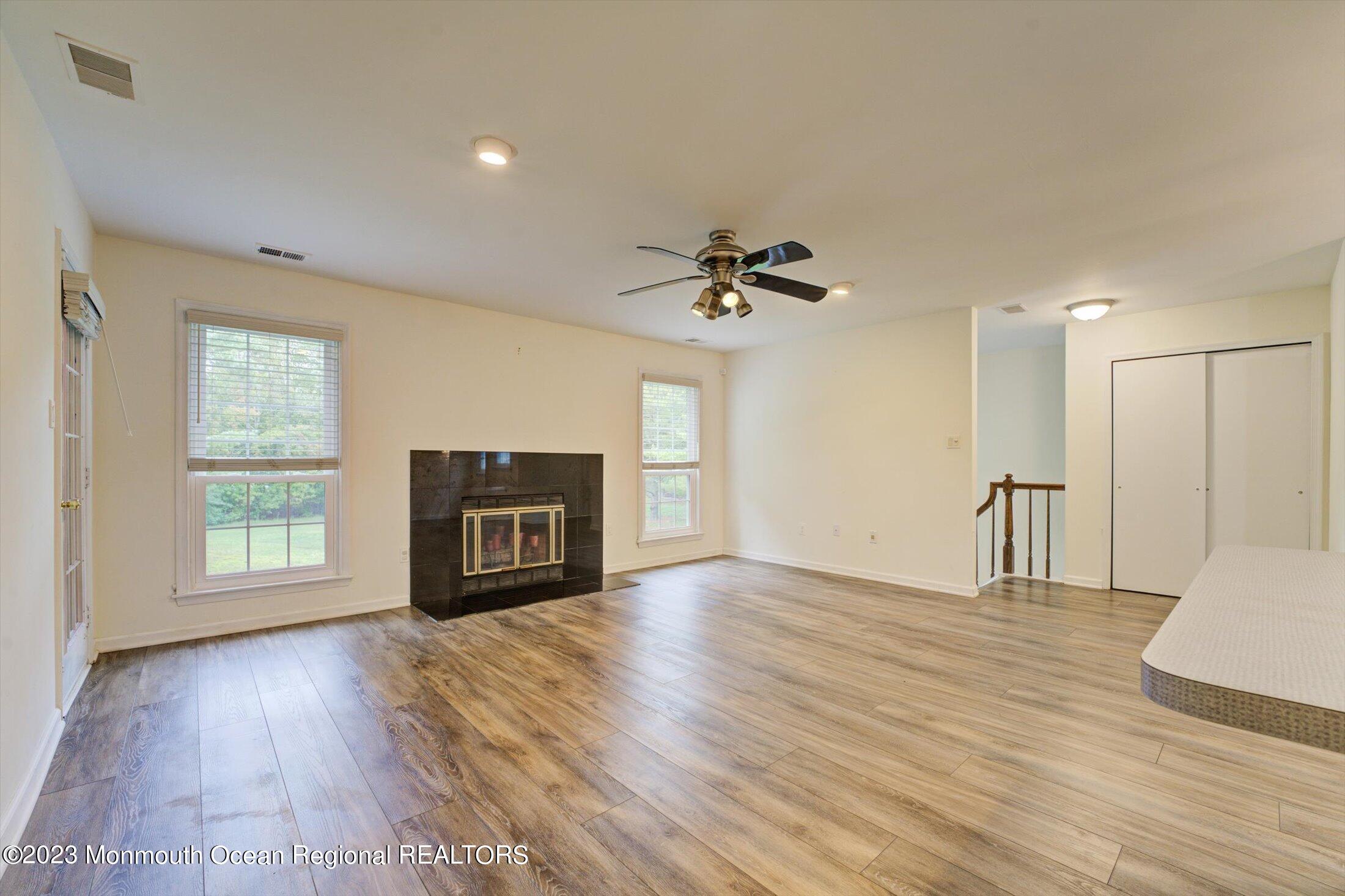 481 Hawthorne Place Morganville, NJ 07751 - Photo 5 of 26 a view of an empty room with a window and wooden floor