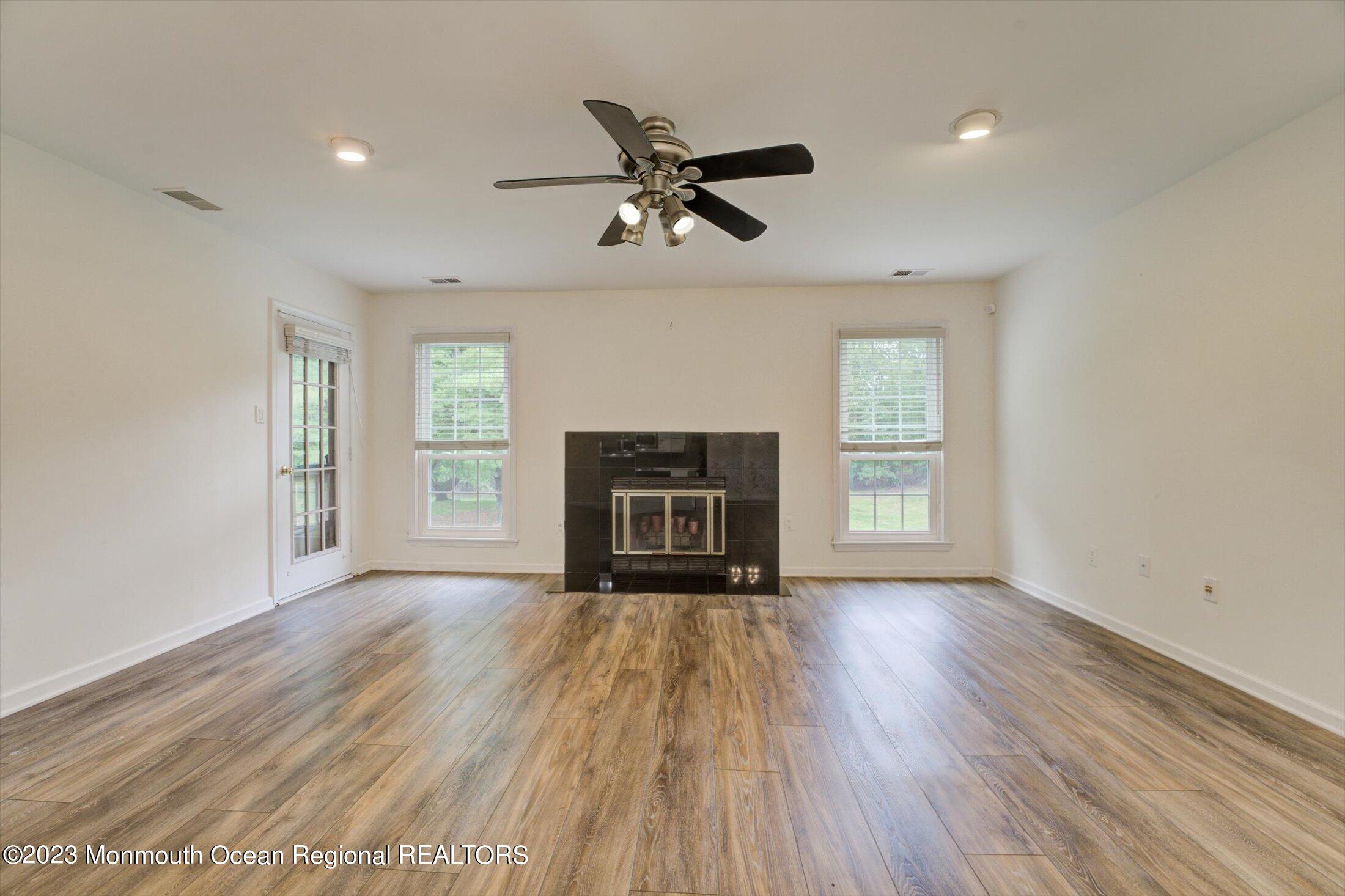 481 Hawthorne Place Morganville, NJ 07751 - Photo 6 of 26 a view of an empty room with a fireplace and a window