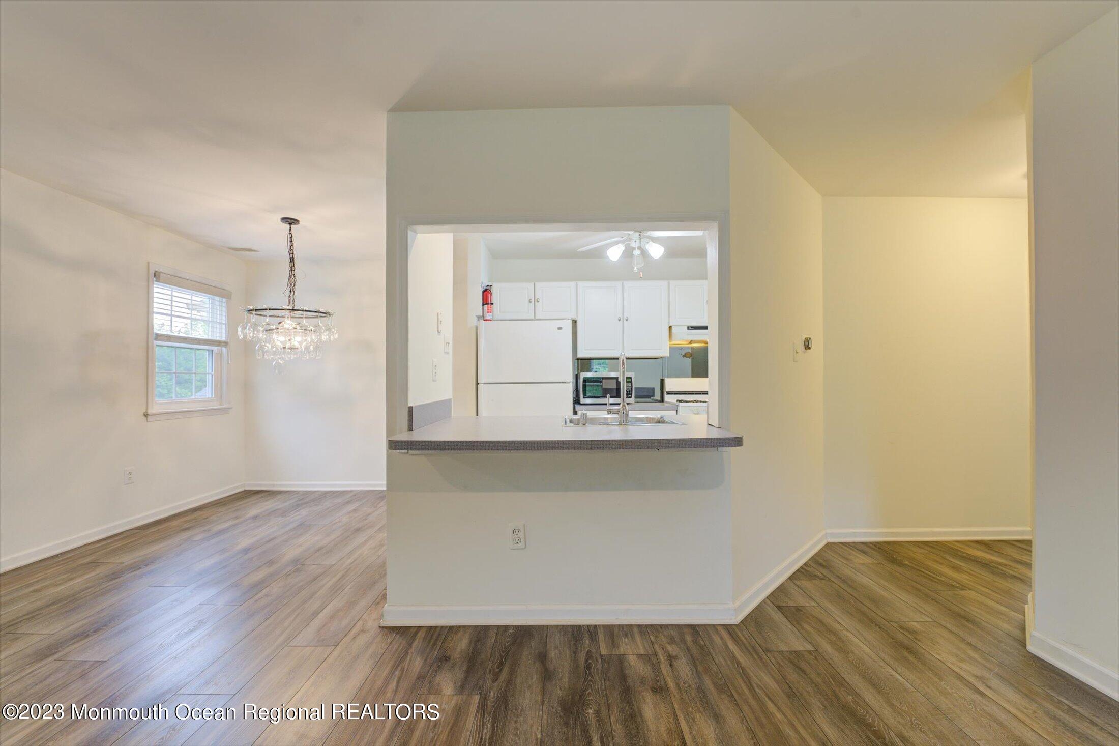 481 Hawthorne Place Morganville, NJ 07751 - Photo 8 of 26 a view of a kitchen with wooden floor and a window