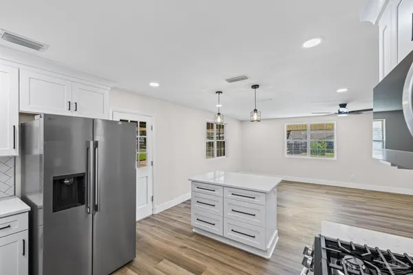 a view of kitchen with furniture and wooden floor