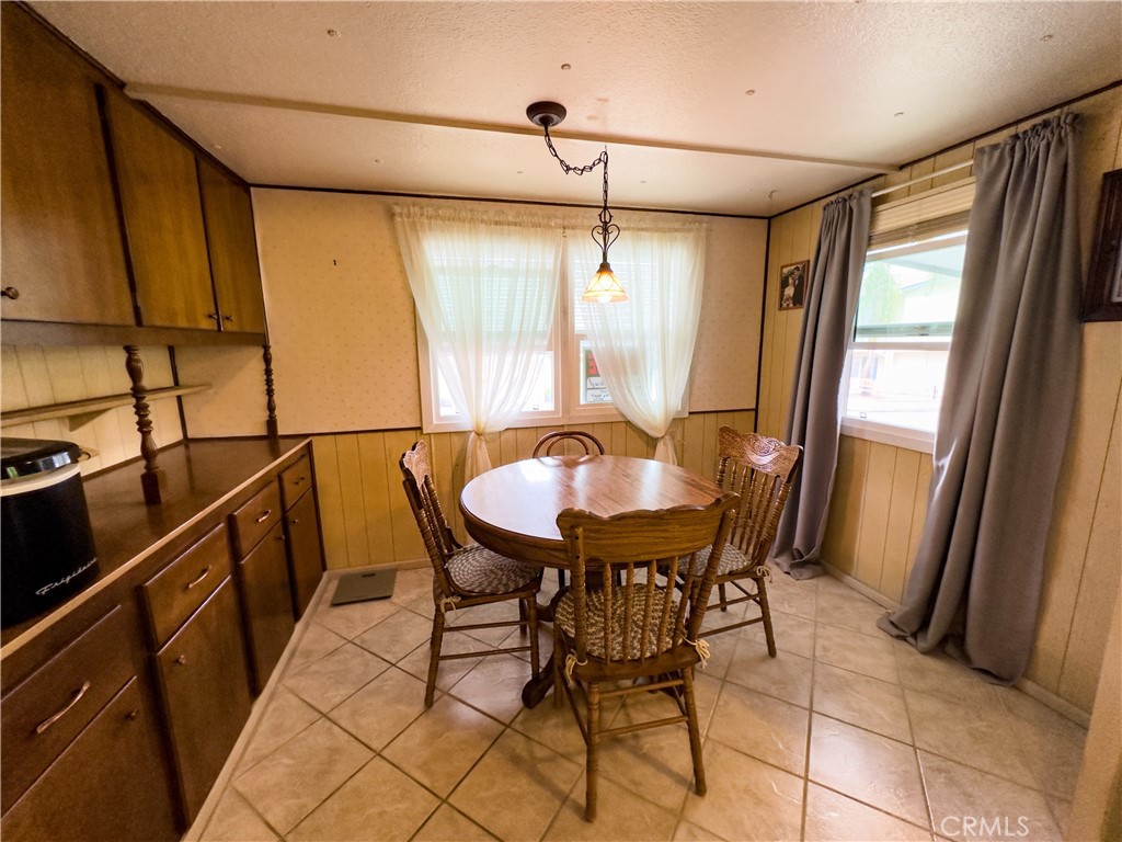 1255 Amethyst Street, Unit 44 Mentone, CA 92359 - Photo 13 of 27 a view of a dining room with furniture and a window