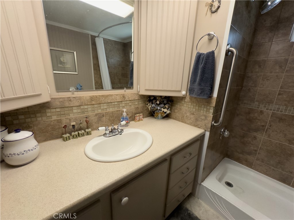 1255 Amethyst Street, Unit 44 Mentone, CA 92359 - Photo 17 of 27 a bathroom with a sink a toilet and shower