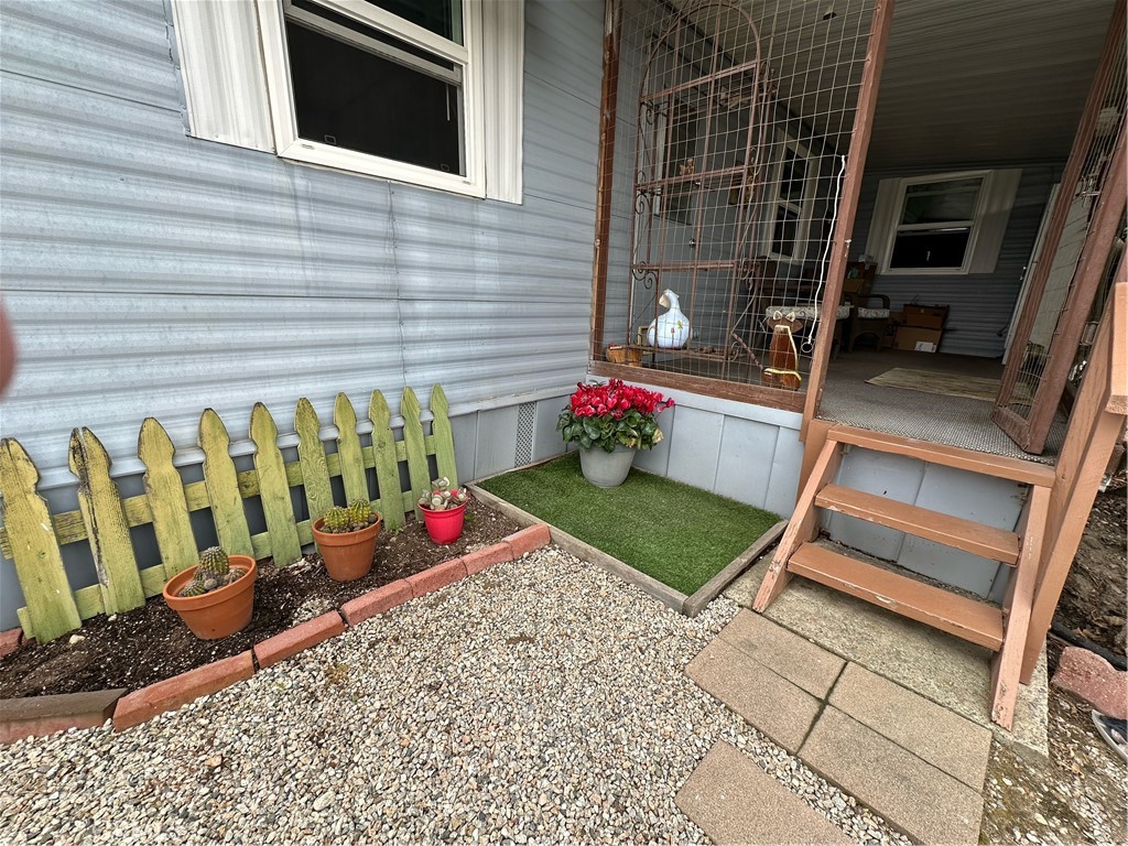 1255 Amethyst Street, Unit 44 Mentone, CA 92359 - Photo 18 of 27 a bench is sitting in front of a door