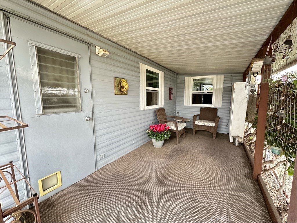 1255 Amethyst Street, Unit 44 Mentone, CA 92359 - Photo 20 of 27 a view of a patio with table and chairs and potted plants
