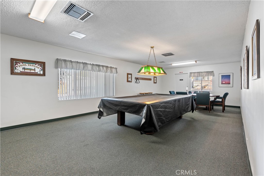 1255 Amethyst Street, Unit 44 Mentone, CA 92359 - Photo 25 of 27 a bedroom with furniture and a wooden floor