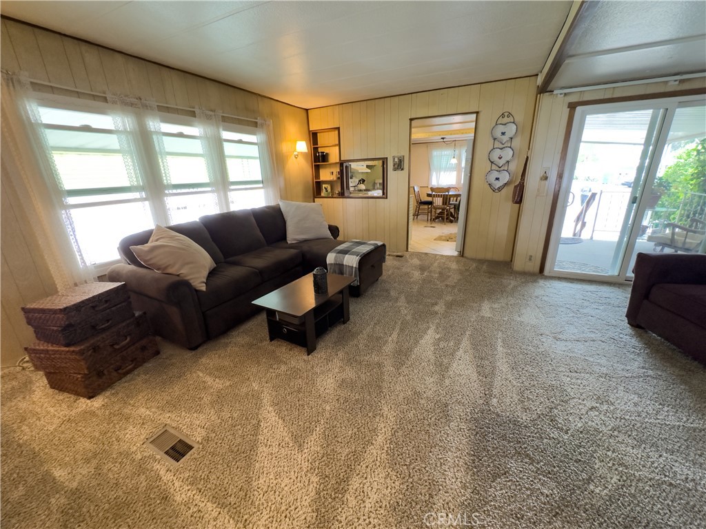 1255 Amethyst Street, Unit 44 Mentone, CA 92359 - Photo 7 of 27 a living room with furniture and large windows