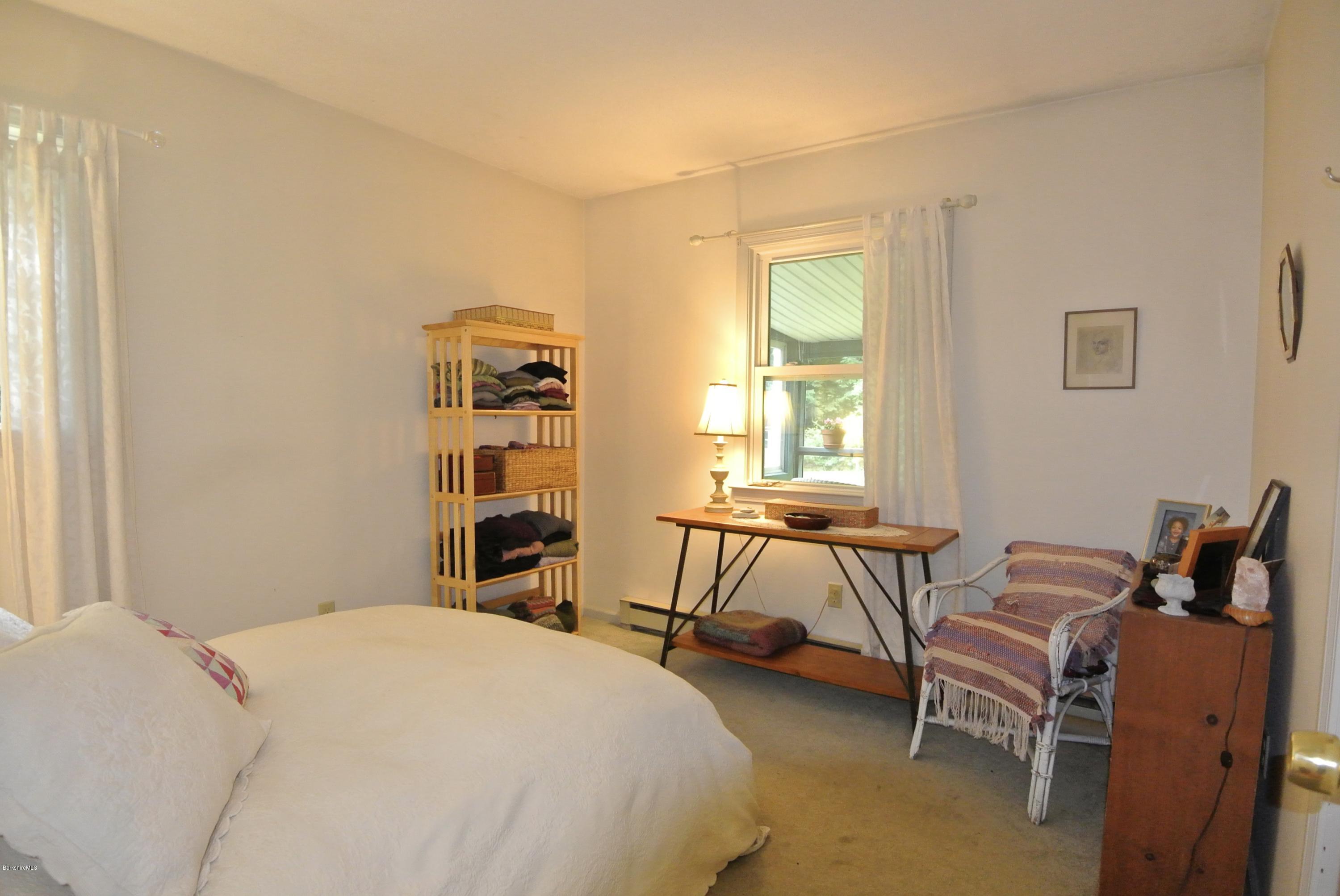 296 Salisbury Road Sheffield, MA 01257 - Photo 13 of 20 a bedroom with a bed and a table chair