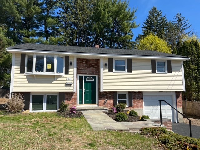 67 Hally Road Lowell, MA 01854 - Photo 1 of 19 a view of a house with a patio and a yard