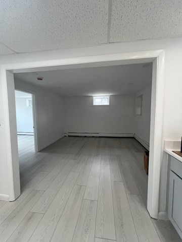 67 Hally Road Lowell, MA 01854 - Photo 17 of 19 an empty room with wooden floor and windows