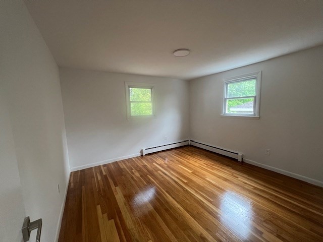 67 Hally Road Lowell, MA 01854 - Photo 5 of 19 a view of an empty room with wooden floor and a window