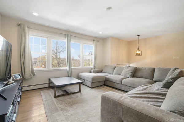 a living room with furniture and a ceiling fan