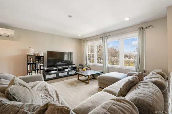 a kitchen with stainless steel appliances a table chairs microwave and cabinets