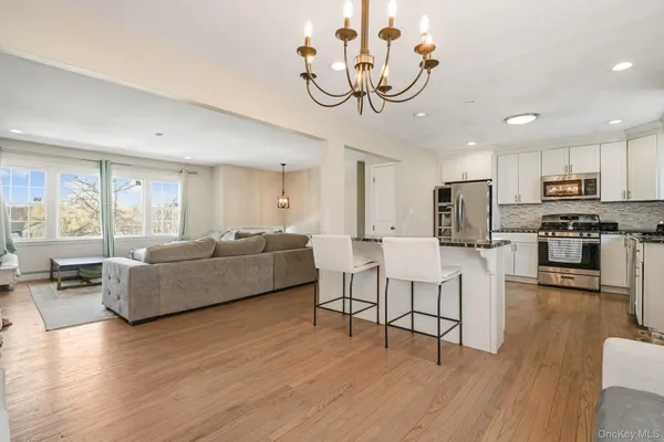 a kitchen with stainless steel appliances a refrigerator sink and microwave