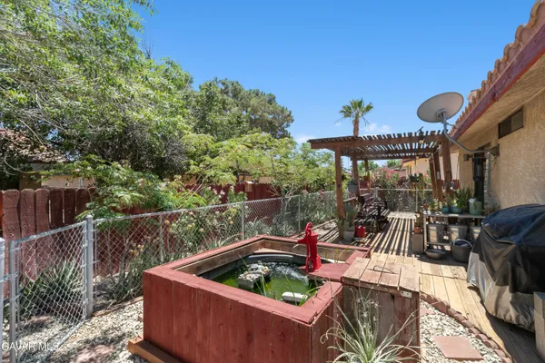 a view of roof deck with a barbeque and furniture
