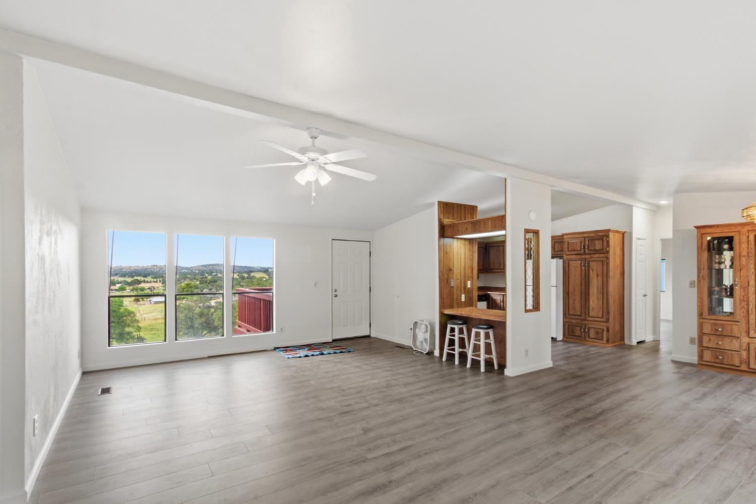 10580 Thompson Way Valley Springs, CA 95252 - Photo 12 of 64 an empty room with wooden floor and windows