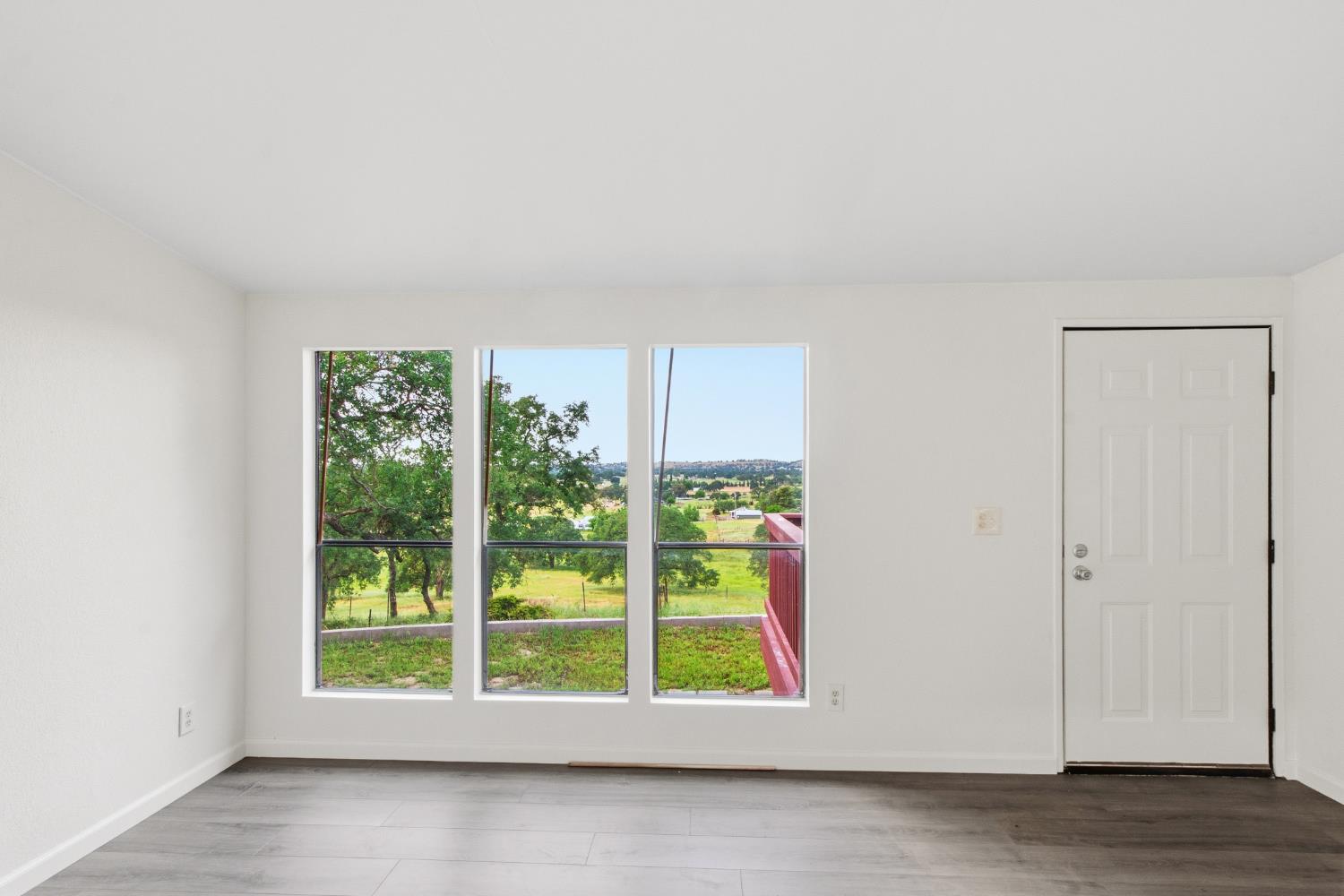 10580 Thompson Way Valley Springs, CA 95252 - Photo 13 of 64 a view of an empty room with wooden floor and a window
