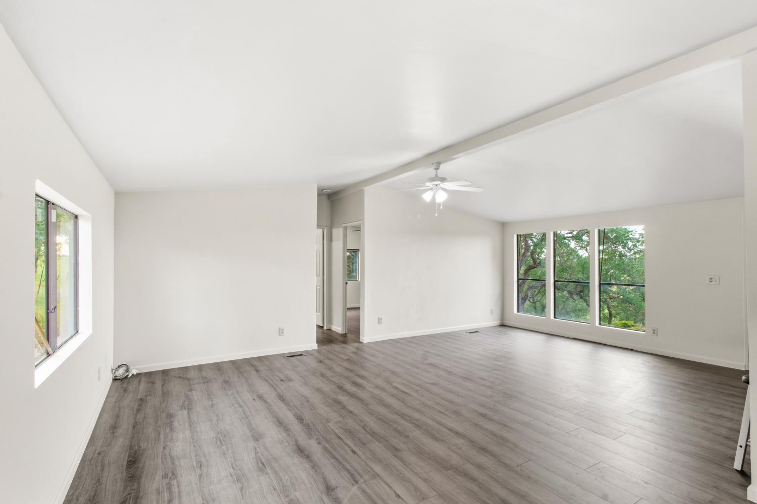 10580 Thompson Way Valley Springs, CA 95252 - Photo 14 of 64 an empty room with wooden floor and windows