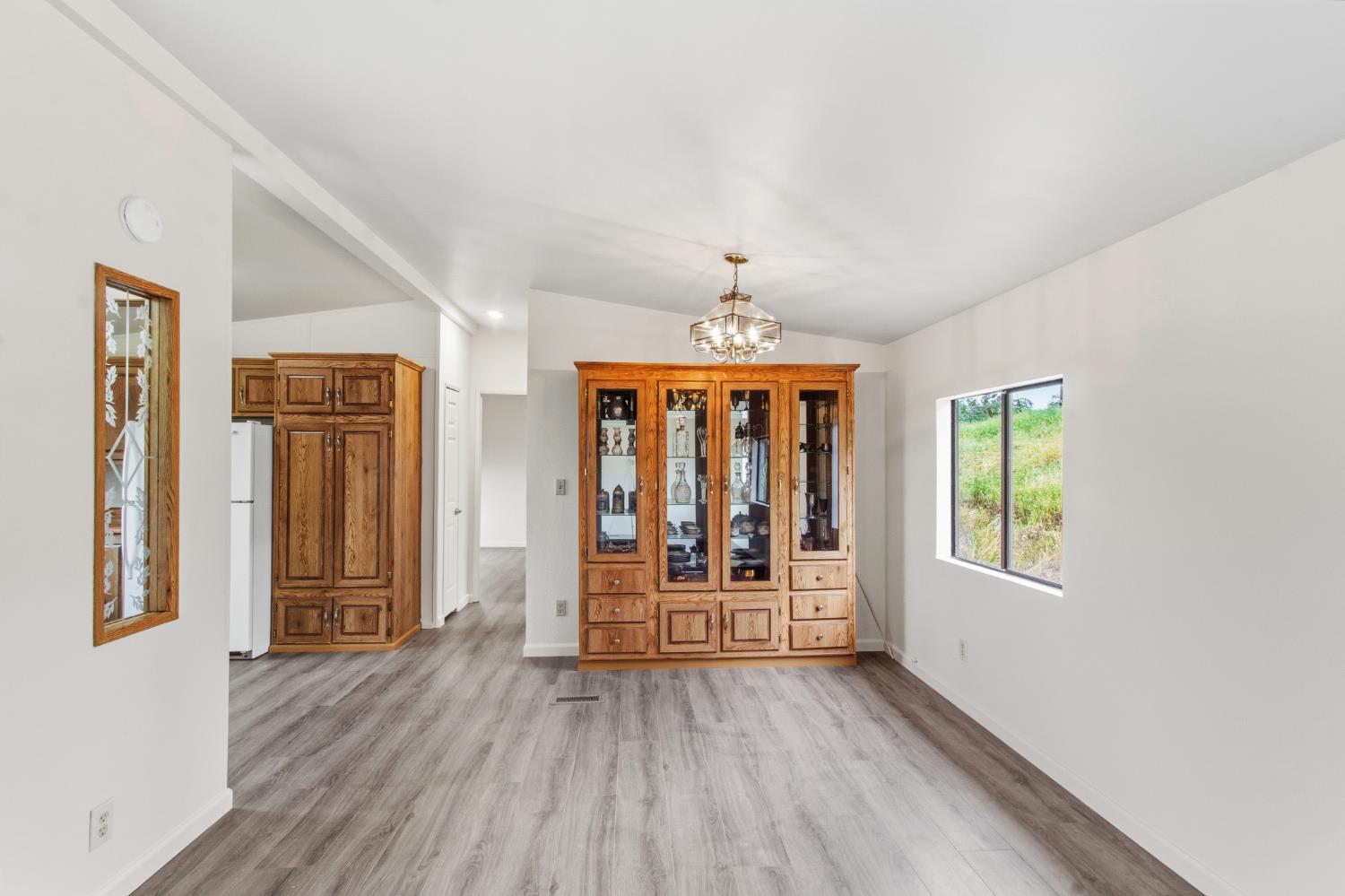 10580 Thompson Way Valley Springs, CA 95252 - Photo 15 of 64 wooden floor in an empty room with a window