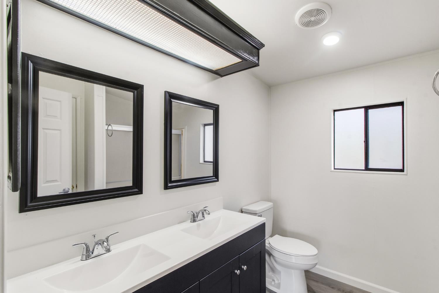 10580 Thompson Way Valley Springs, CA 95252 - Photo 22 of 64 a bathroom with 2 sink and a mirror