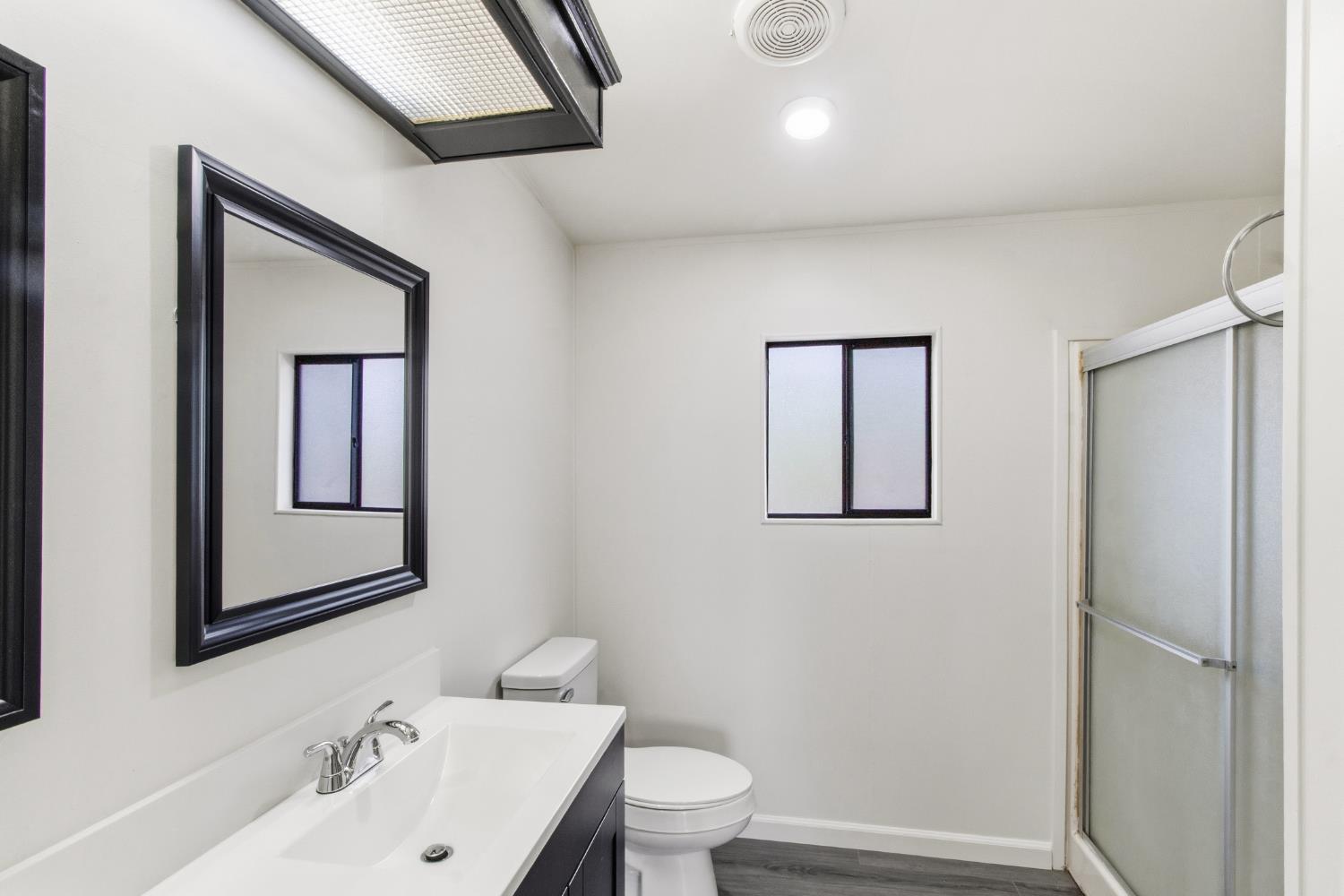10580 Thompson Way Valley Springs, CA 95252 - Photo 23 of 64 a bathroom with a toilet sink and mirror