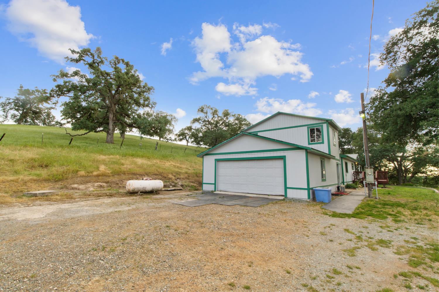 10580 Thompson Way Valley Springs, CA 95252 - Photo 47 of 64 a view of a house with a yard and large tree