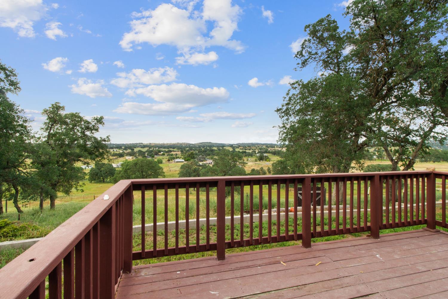 10580 Thompson Way Valley Springs, CA 95252 - Photo 7 of 64 a balcony with wooden floor and fence