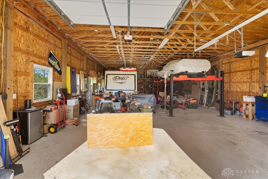841 Willow Road Springfield, OH 45502 - Photo 50 of 64 This spacious garage offers ample room for vehicles and projects, featuring convenient access and durable concrete flooring.