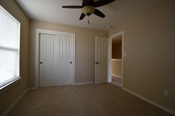 15918 Windermere Drive, Unit 315 Pflugerville, TX 78660 - Photo 11 of 13 an empty room with windows and closet