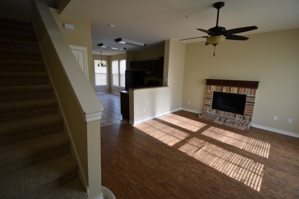15918 Windermere Drive, Unit 315 Pflugerville, TX 78660 - Photo 2 of 13 a living room with furniture and a fireplace
