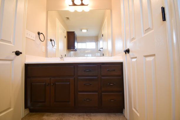 15918 Windermere Drive, Unit 315 Pflugerville, TX 78660 - Photo 7 of 13 a bathroom with a double vanity sink and mirror