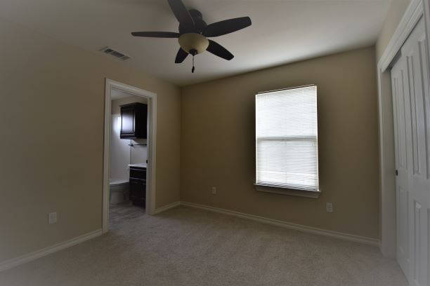 15918 Windermere Drive, Unit 315 Pflugerville, TX 78660 - Photo 8 of 13 an empty room with windows and closet