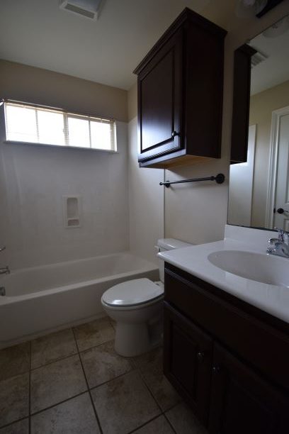 15918 Windermere Drive, Unit 315 Pflugerville, TX 78660 - Photo 10 of 13 a bathroom with a sink a toilet and bathtub