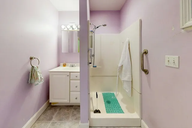 a living room with stainless steel appliances kitchen island granite countertop furniture and a large window