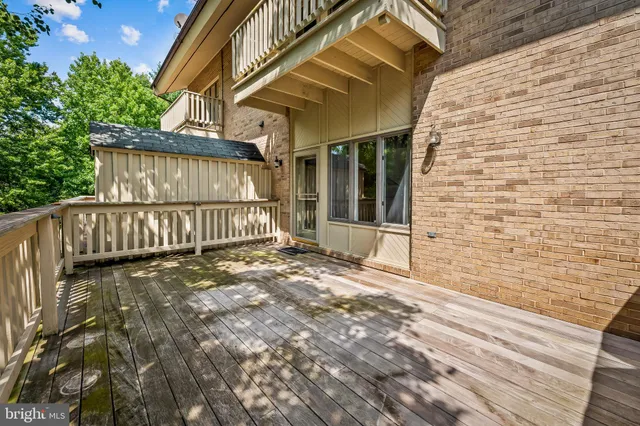 a view of a house with a wooden deck