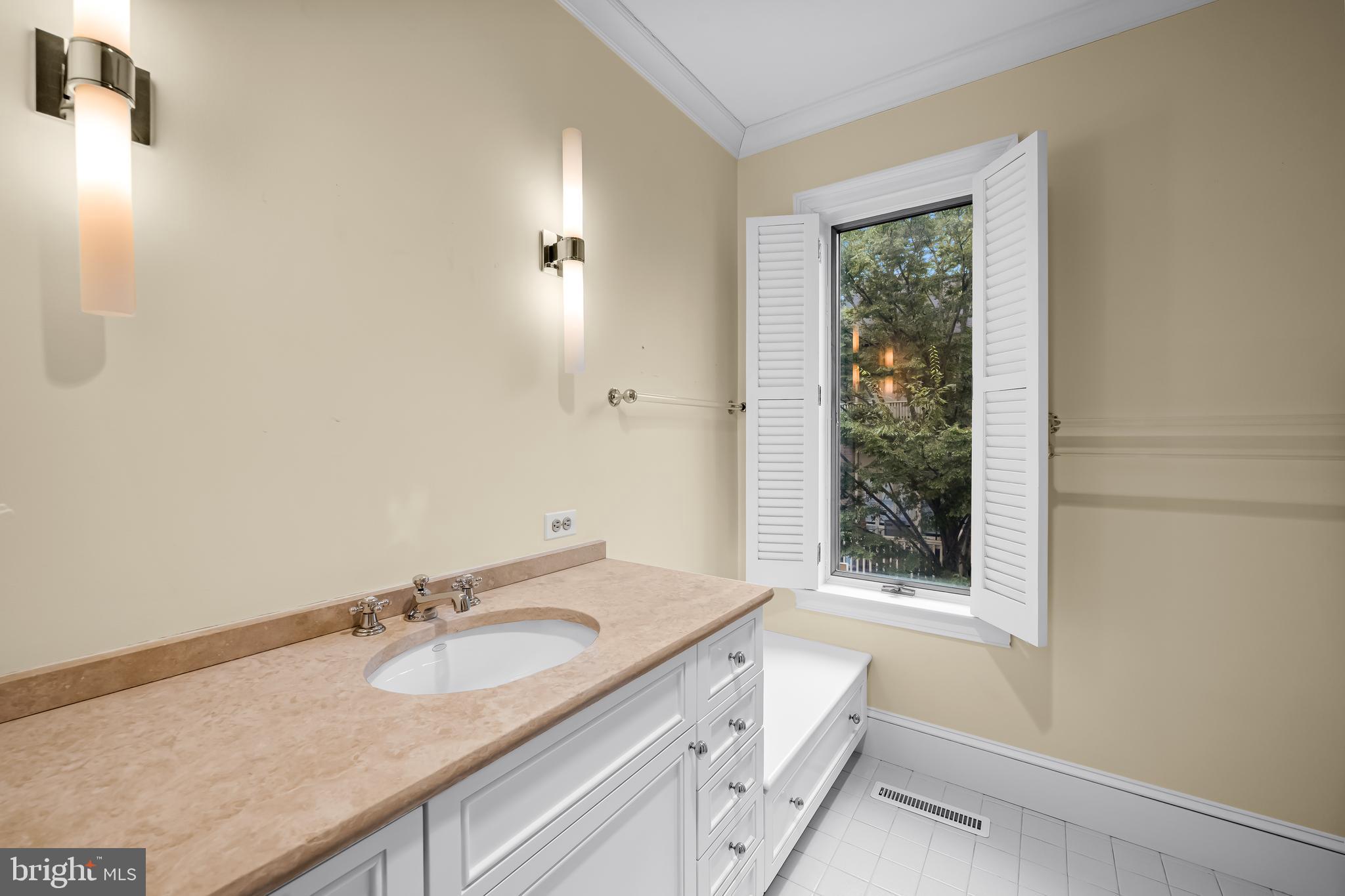 5700 Coley Court Baltimore, MD 21210 - Photo 21 of 53 a bathroom with a granite countertop sink and a mirror