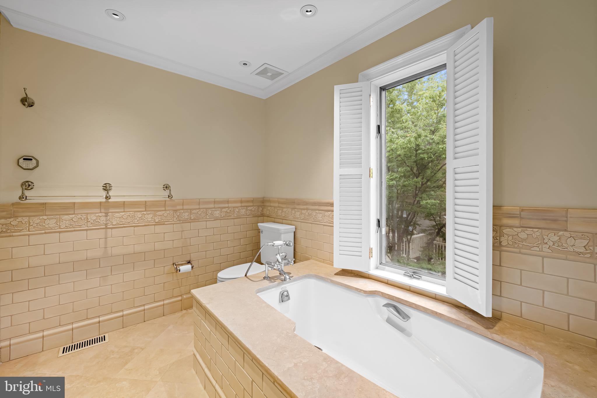 5700 Coley Court Baltimore, MD 21210 - Photo 26 of 53 a bathroom with a tub sink and glass door