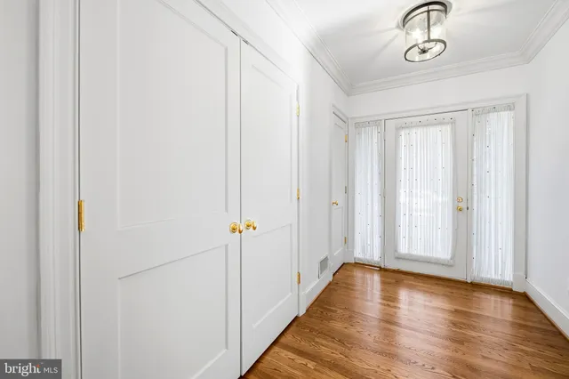 a view of a room with wooden floor
