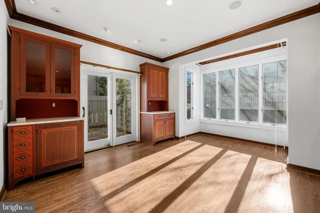 a view of front door with wooden floor and cabinet