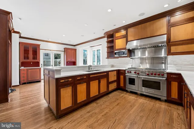 a kitchen with stainless steel appliances granite countertop a stove and a sink