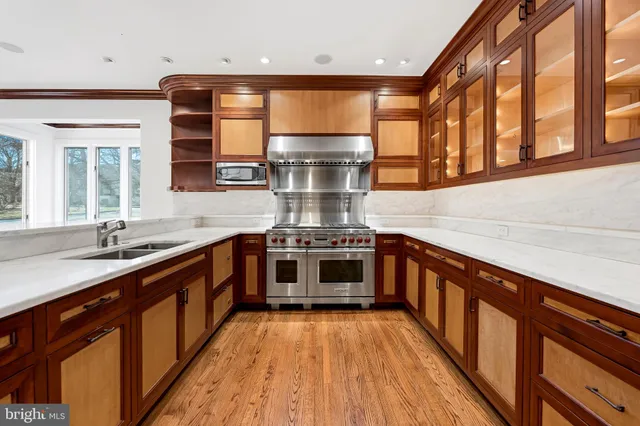 a large kitchen with stainless steel appliances granite countertop a stove and a sink