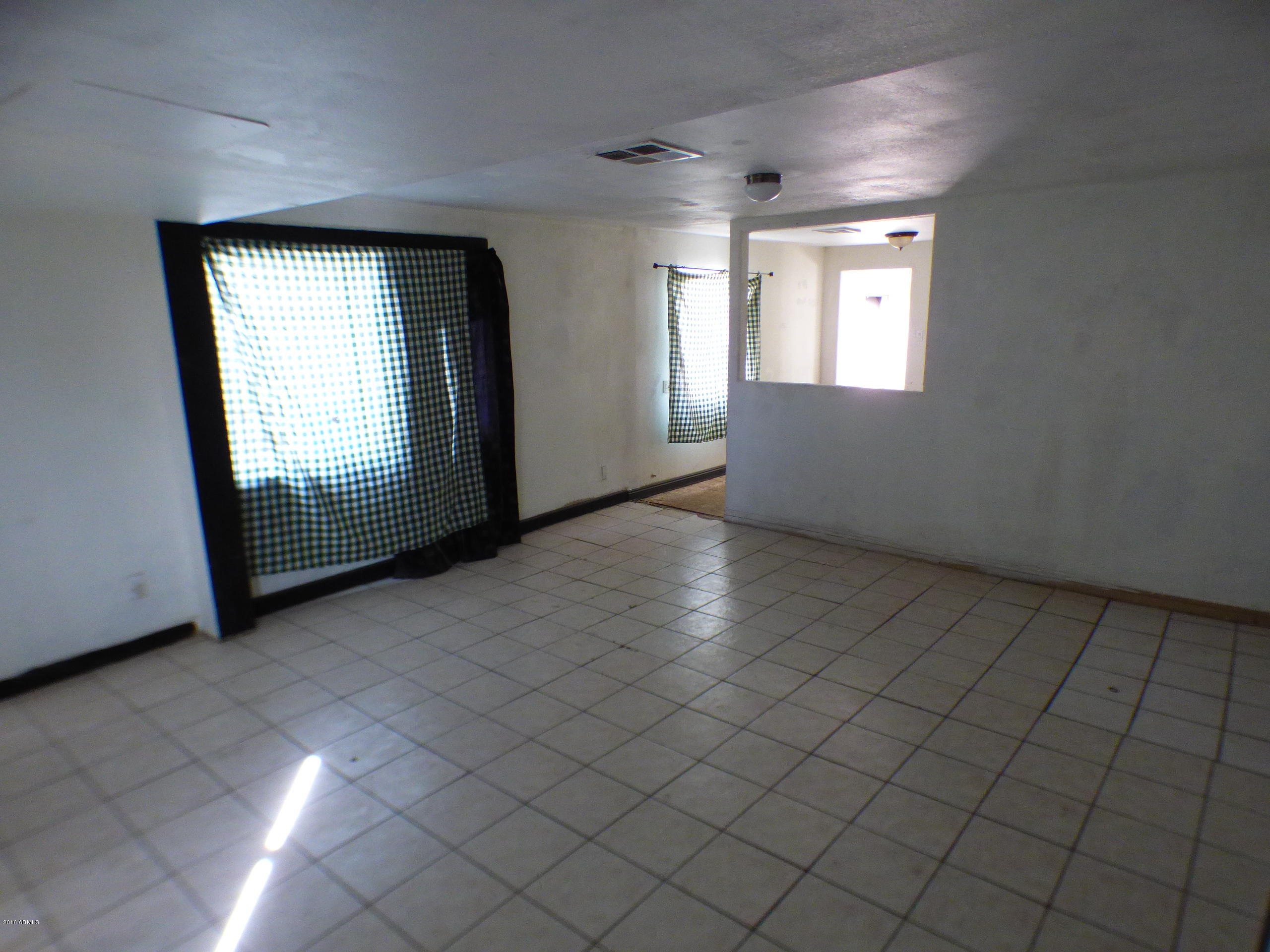 3520 West Coronado Road Phoenix, AZ 85009 - Photo 5 of 13 an empty room with windows