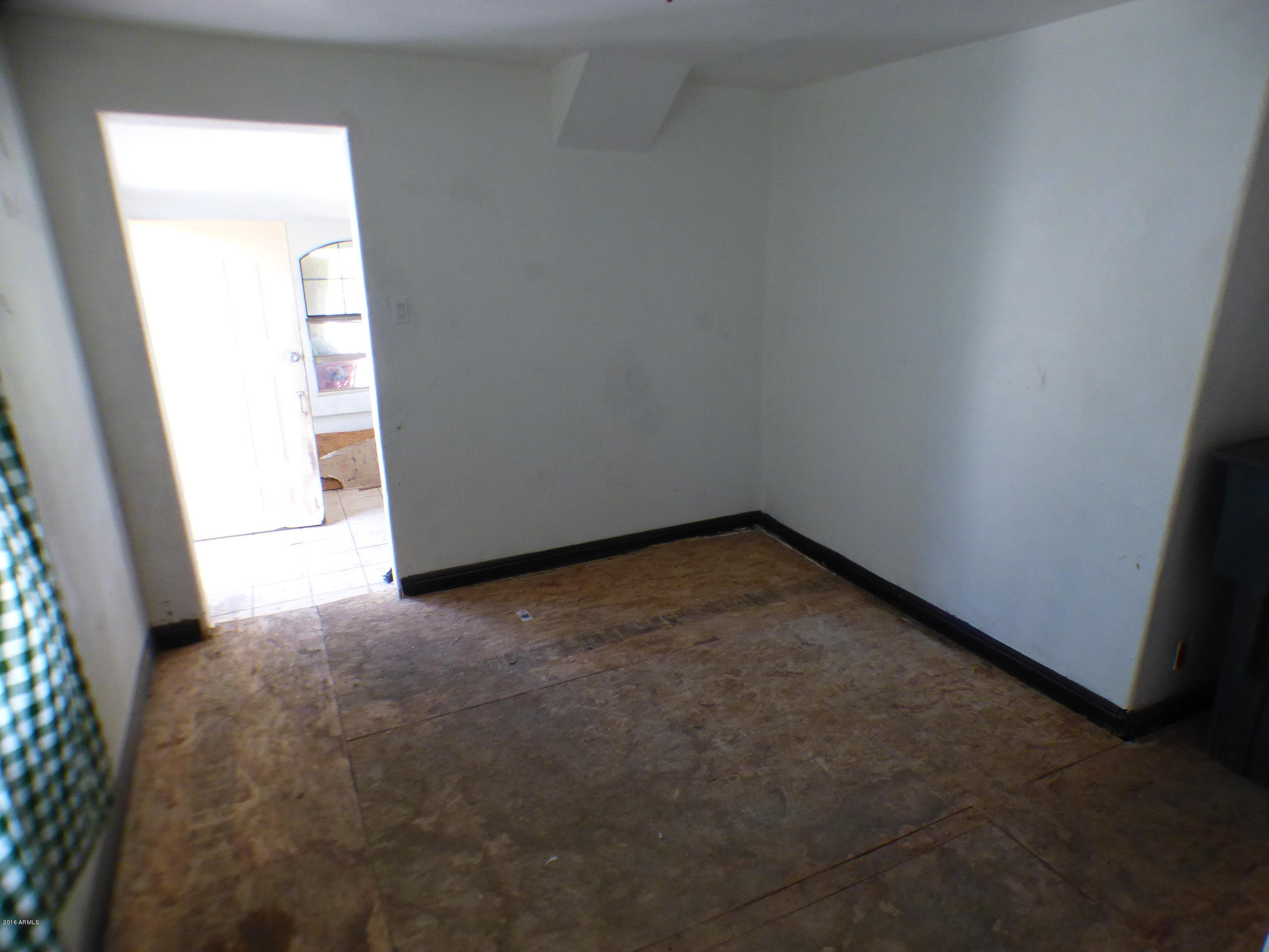 3520 West Coronado Road Phoenix, AZ 85009 - Photo 8 of 13 an empty room with windows