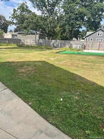 a view of a big yard with a small yard and large trees