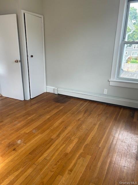309 South Broadway, Unit 2 UPPER LEVEL Lindenhurst, NY 11757 - Photo 8 of 13 a view of an empty room with wooden floor and a window