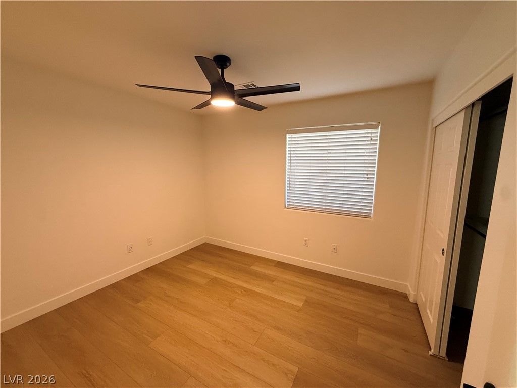2122 Hidden Ranch Terrace Henderson, NV 89052 - Photo 13 of 20 Hardwood-style flooring and a functional ceiling fan define this comfortable bedroom.